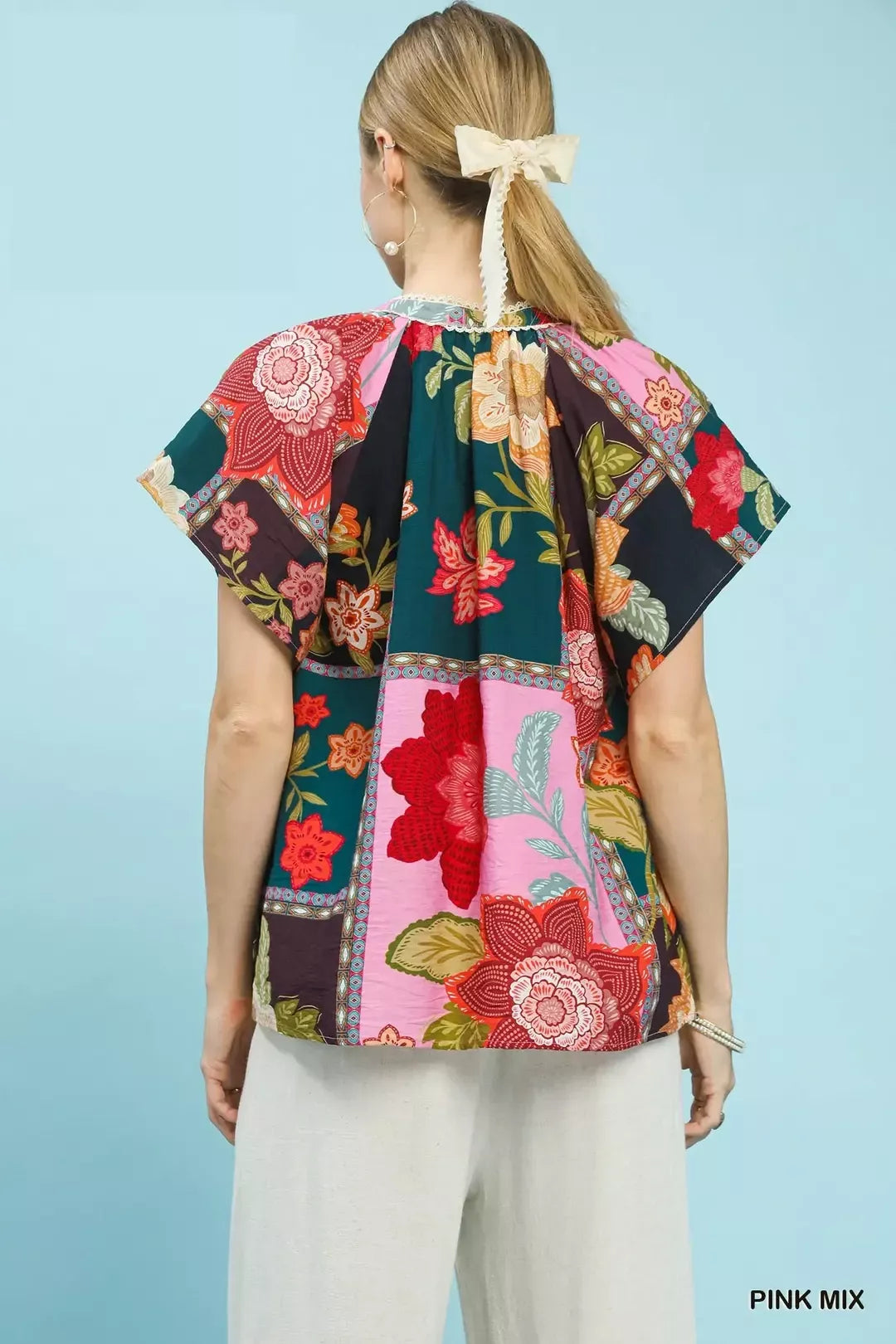 lightweight boho patchwork blouse with tassel tie neckline and floral-inspired print details