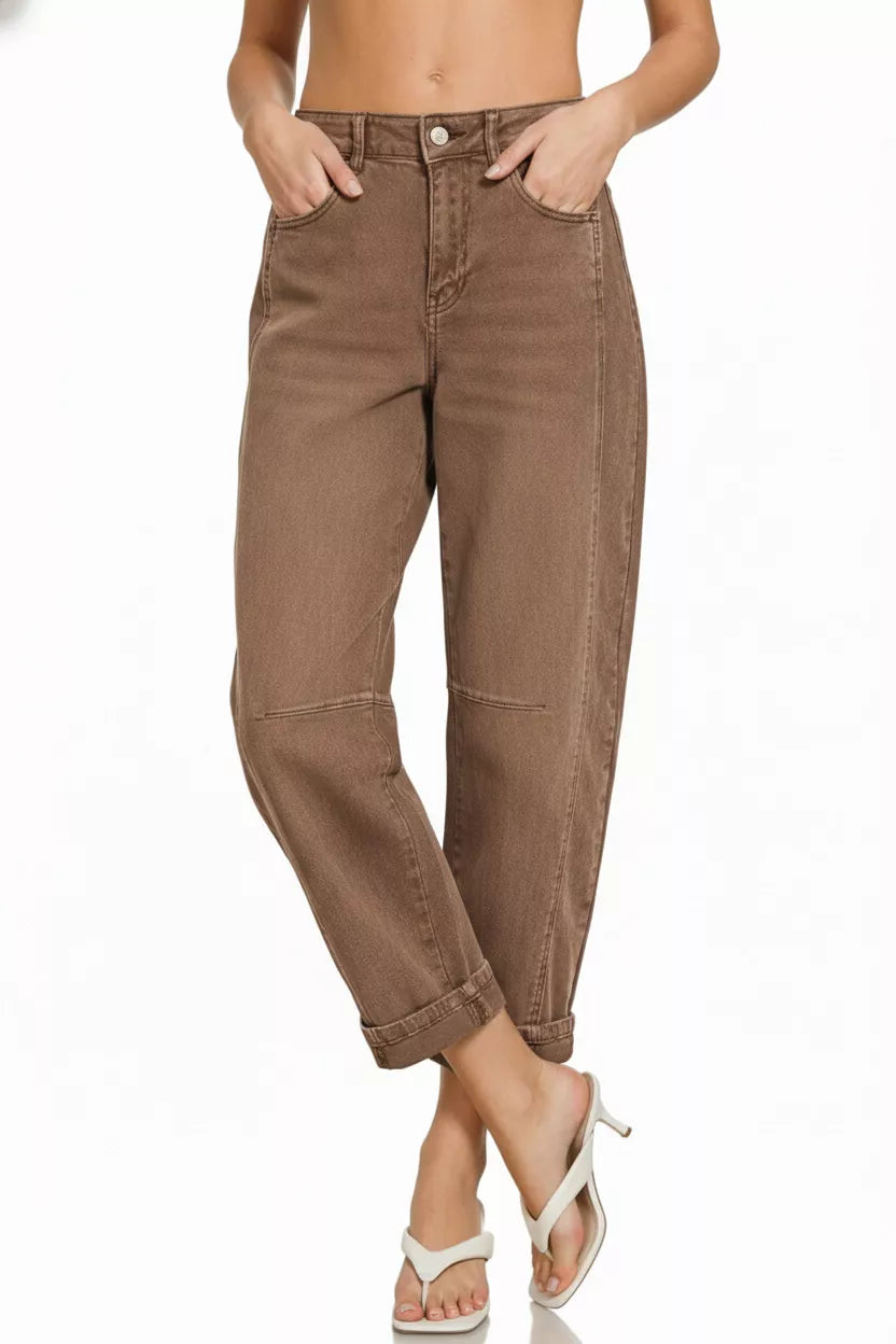 Model wearing brown high rise barrel-leg cropped jeans with cuffed hem and relaxed fit