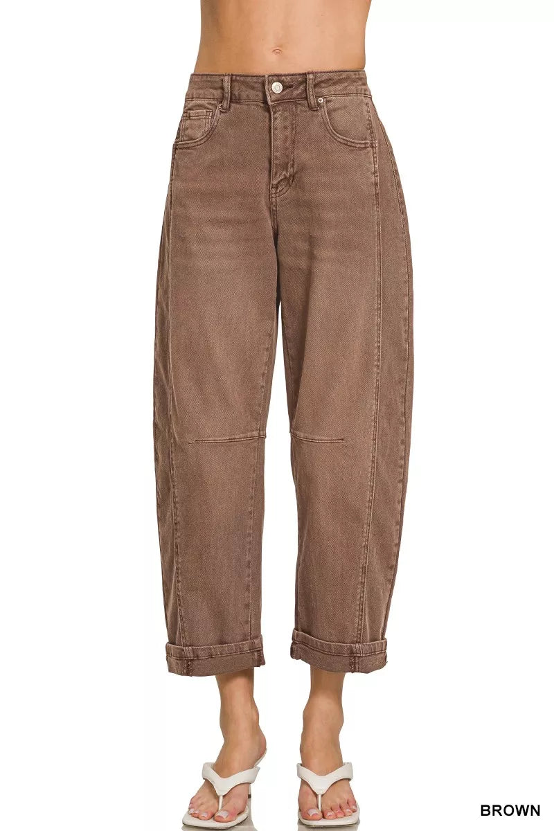 Model wearing brown high rise barrel-leg cropped jeans with cuffed hem and relaxed fit