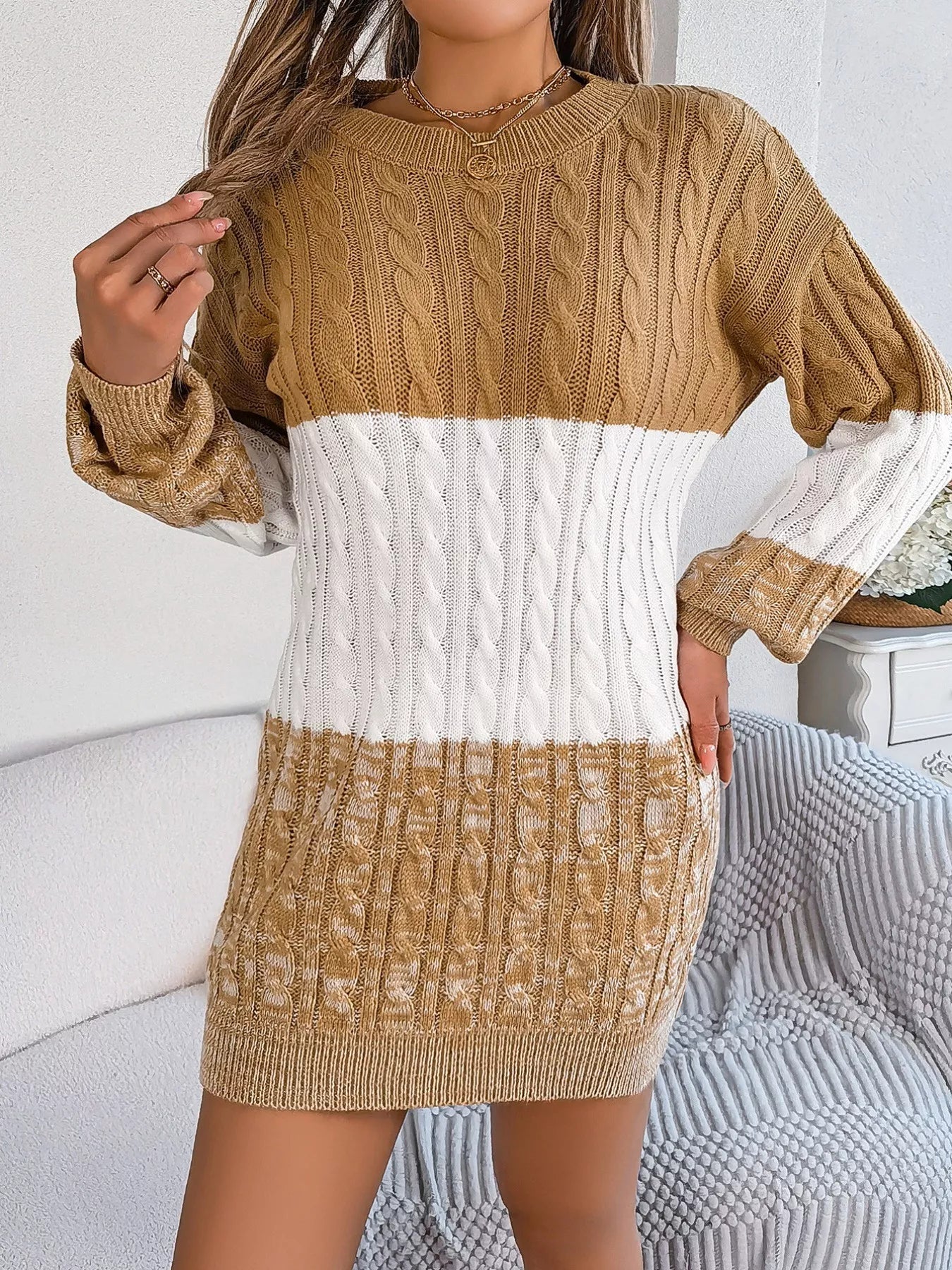 Woman wearing a colorblock cable knit sweater dress in warm winter tones — cozy long sleeve knit from A Whimsical Affair.