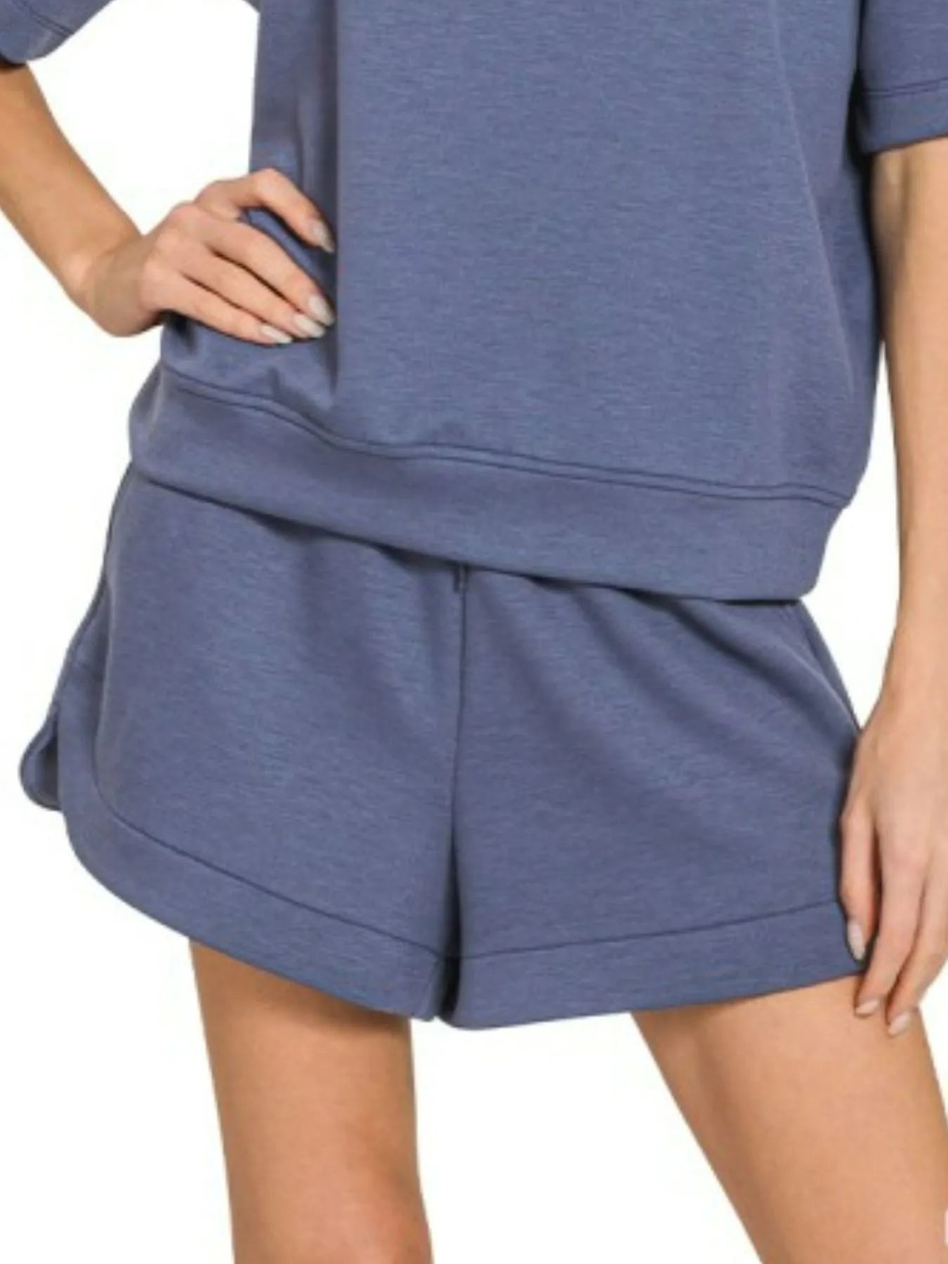 Woman wearing Zenana Scuba Short Sleeve Top and Shorts Set in blue indigo, casual oversized loungewear outfit