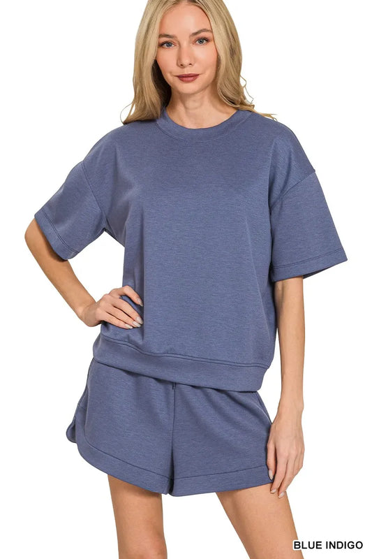 Woman wearing Zenana Scuba Short Sleeve Top and Shorts Set in blue indigo, casual oversized loungewear outfit